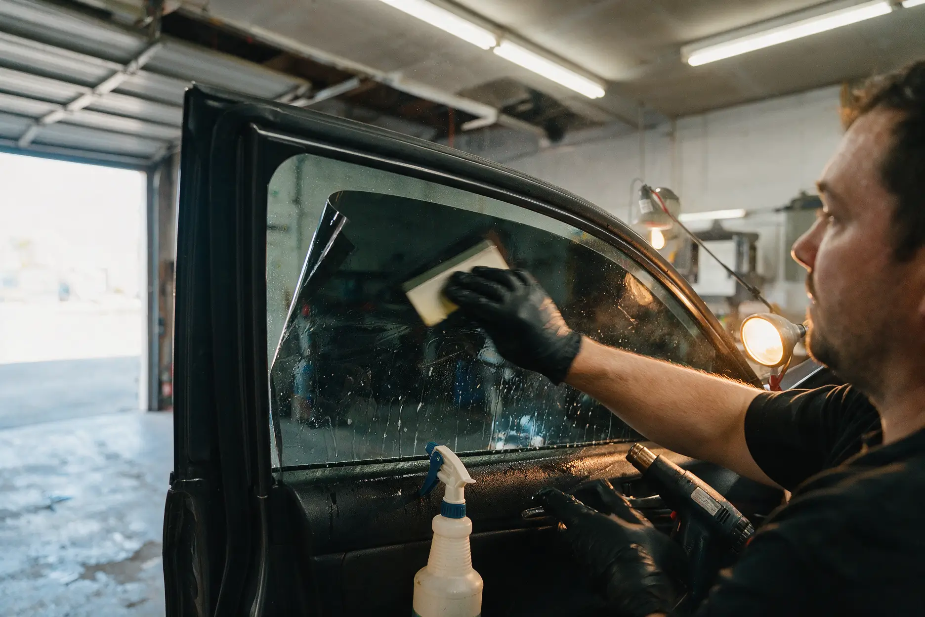Window tint film being applied to a car door